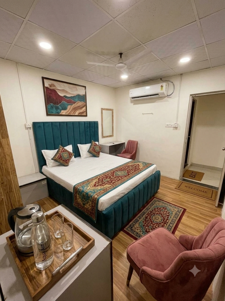 Guest room at Rudra Residency with a teal button-tufted headboard and mountain artwork
